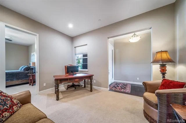 a living room with furniture and a lamp