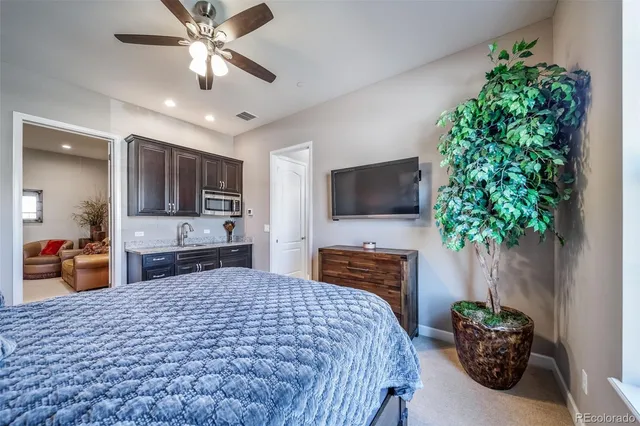 a bedroom with a bed and a flat screen television