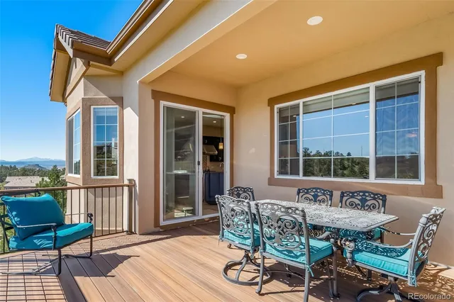 a view of a patio with table and chairs and wooden floor