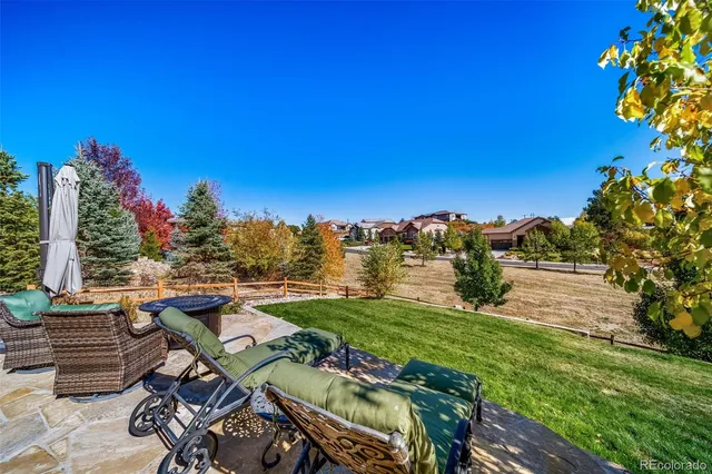 a view of a patio with table and chairs and potted plants