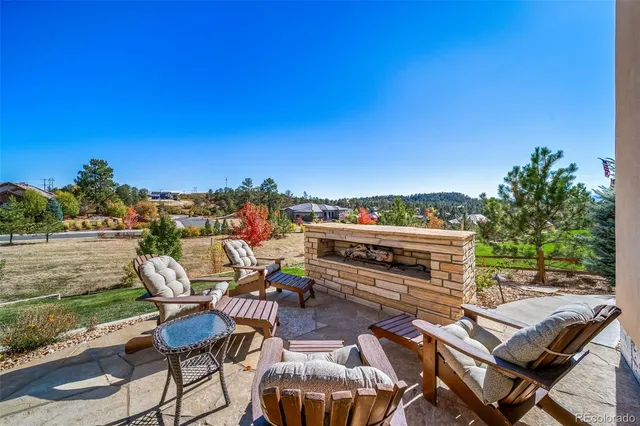 a view of a chairs and table in patio with a lake view