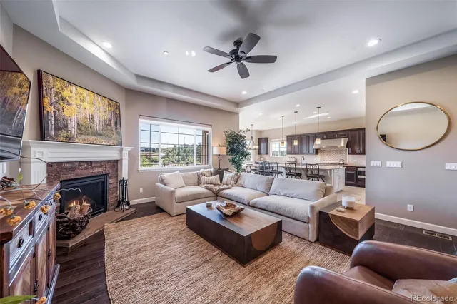 a living room with furniture fireplace and a large window