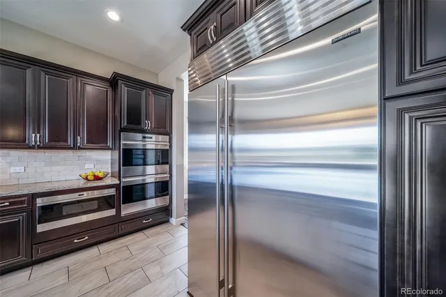 a kitchen with stainless steel appliances and cabinets