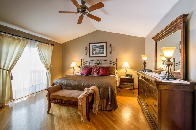 293 Ridge Road North Aurora, IL 60542 - Photo 9 of 21 a bedroom with a bed and wooden floor