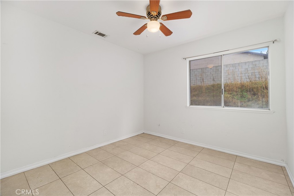 6897 Crest Avenue Riverside, CA 92503 - Photo 22 of 26 an empty room with windows and fan
