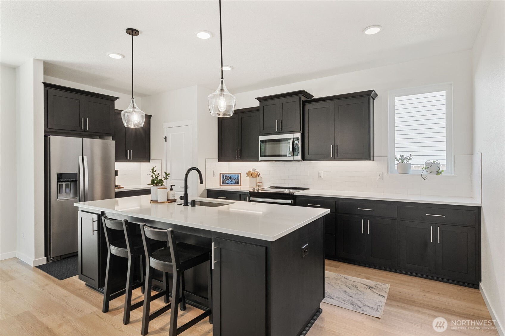 1090 Rw Fletcher Street Winlock, WA 98596 - Photo 5 of 37 a kitchen with stainless steel appliances granite countertop a sink a stove a refrigerator and island