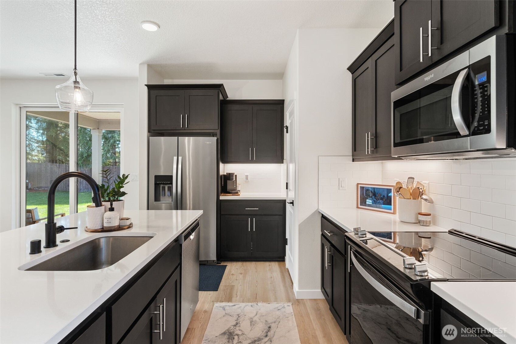 1090 Rw Fletcher Street Winlock, WA 98596 - Photo 6 of 37 a kitchen with a sink stove top oven and refrigerator