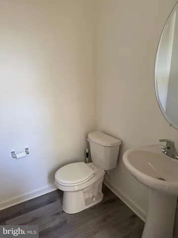 a white toilet sitting next to a bathroom sink