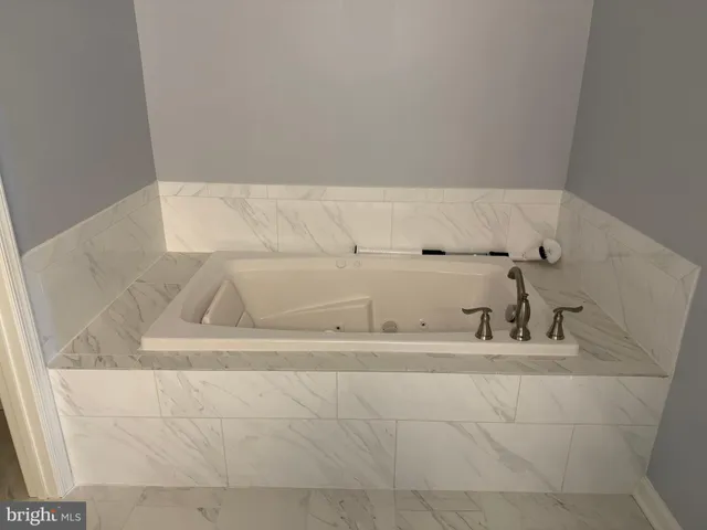 a bathroom with a shower sink vanity and mirror