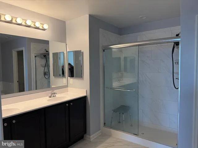 a white toilet sitting next to a shower