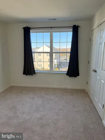 a white toilet sitting next to a bath tub and a shower