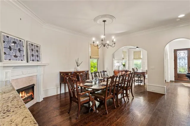 a kitchen with a stove and wooden floor