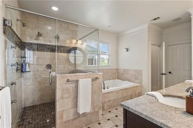 a bedroom with a large bed a flat tv screen and a window