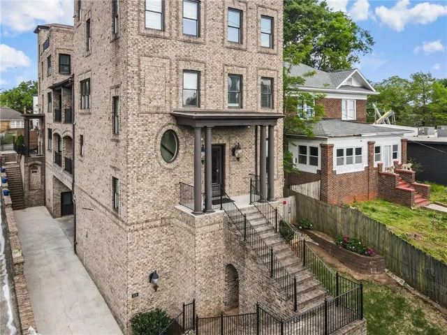 a living room with furniture a dining table and a chandelier