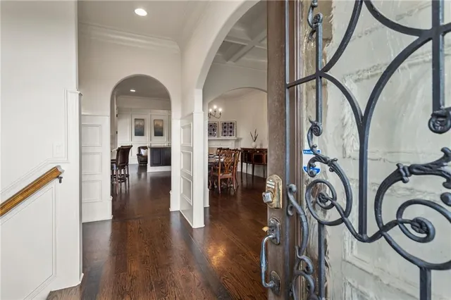 a view of a dining room with furniture a chandelier and wooden floor