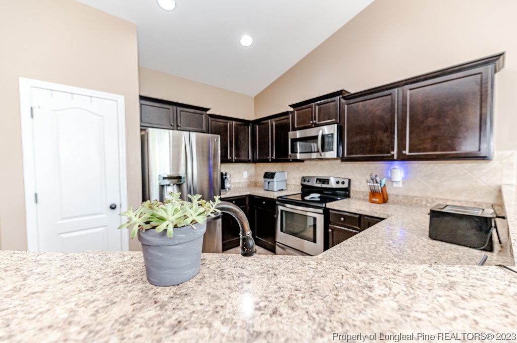 463 Juno Drive Broadway, NC 27505 - Photo 13 of 30 a kitchen with a refrigerator and microwave