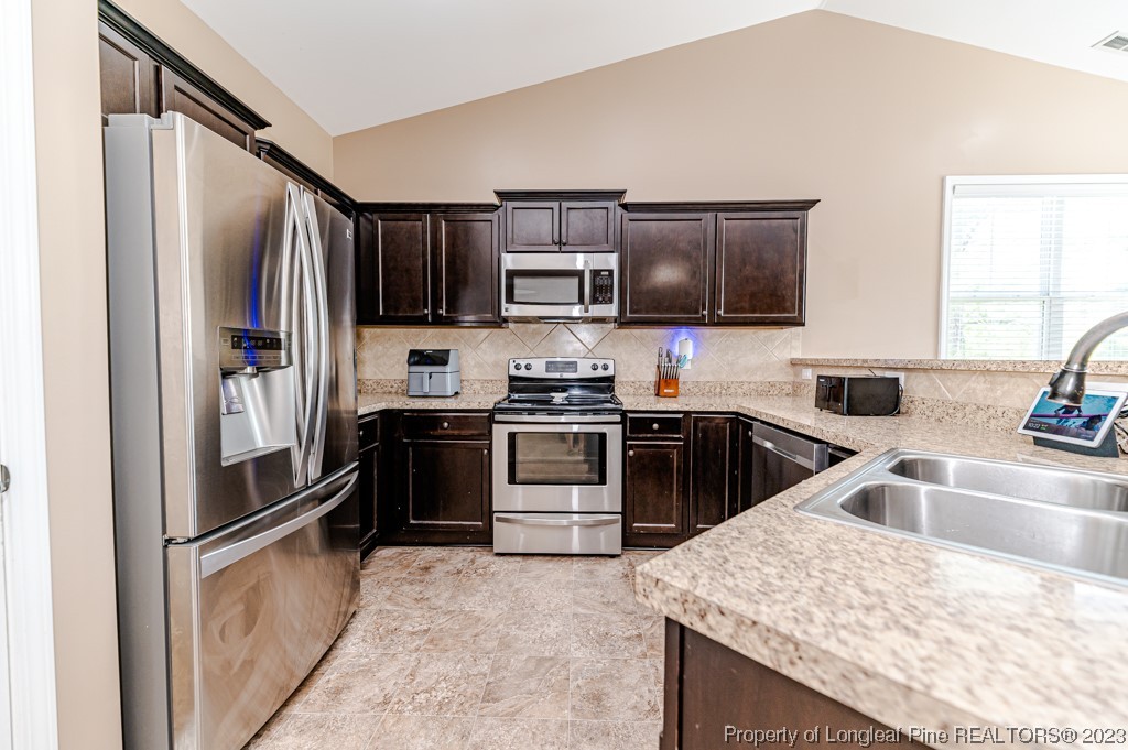 463 Juno Drive Broadway, NC 27505 - Photo 14 of 30 a kitchen with kitchen island a sink stove and refrigerator