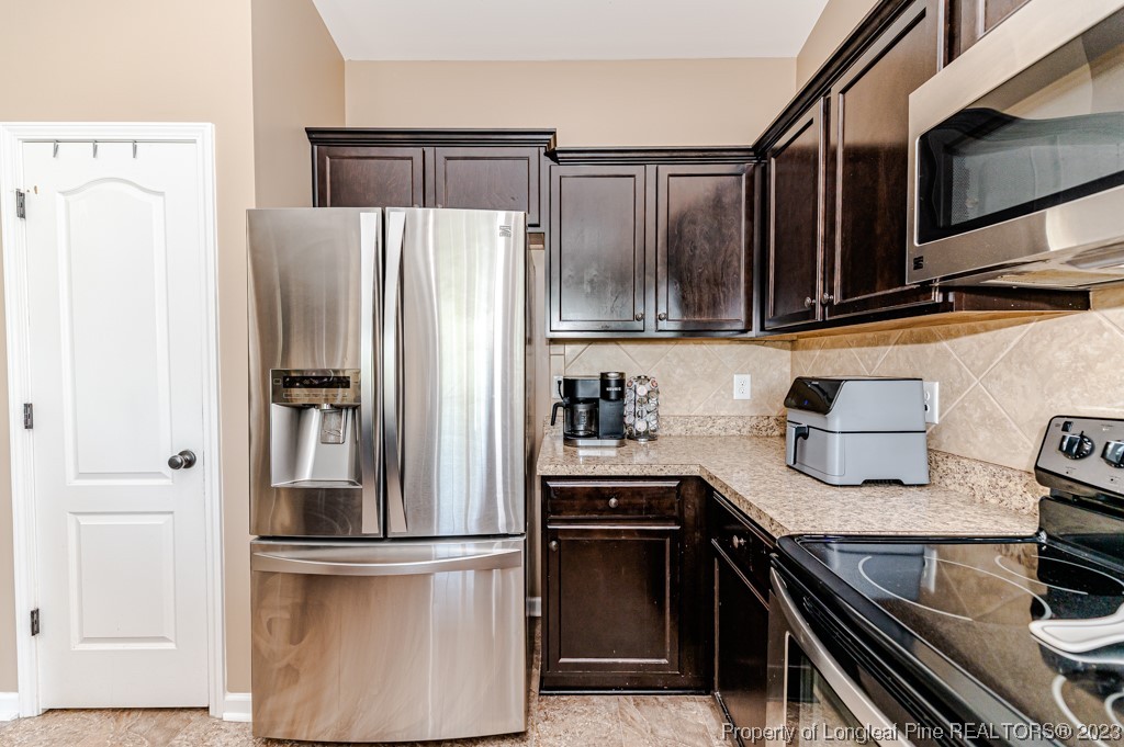 463 Juno Drive Broadway, NC 27505 - Photo 15 of 30 a kitchen with stainless steel appliances and refrigerator