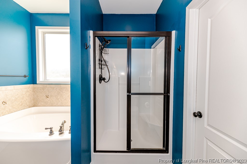 463 Juno Drive Broadway, NC 27505 - Photo 19 of 30 a bathroom with a bathtub and a shower