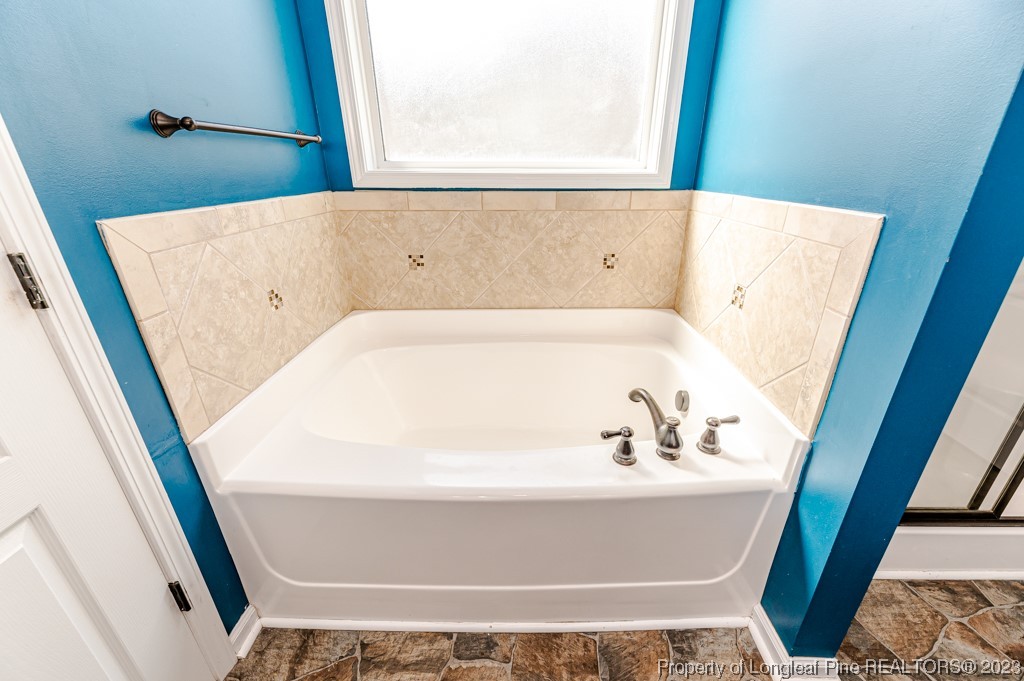 463 Juno Drive Broadway, NC 27505 - Photo 20 of 30 a bath tub sitting in a bathroom next to a sink