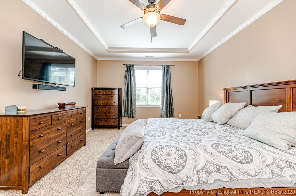 463 Juno Drive Broadway, NC 27505 - Photo 21 of 30 a bedroom with a large bed and a flat tv screen on dresser