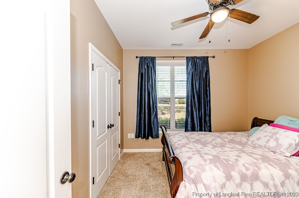 463 Juno Drive Broadway, NC 27505 - Photo 24 of 30 a bed sitting in a bedroom next to a window