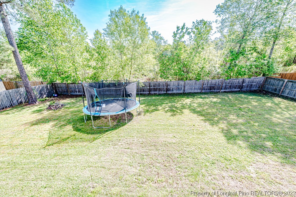 463 Juno Drive Broadway, NC 27505 - Photo 26 of 30 a view of a swimming pool with a patio and a yard