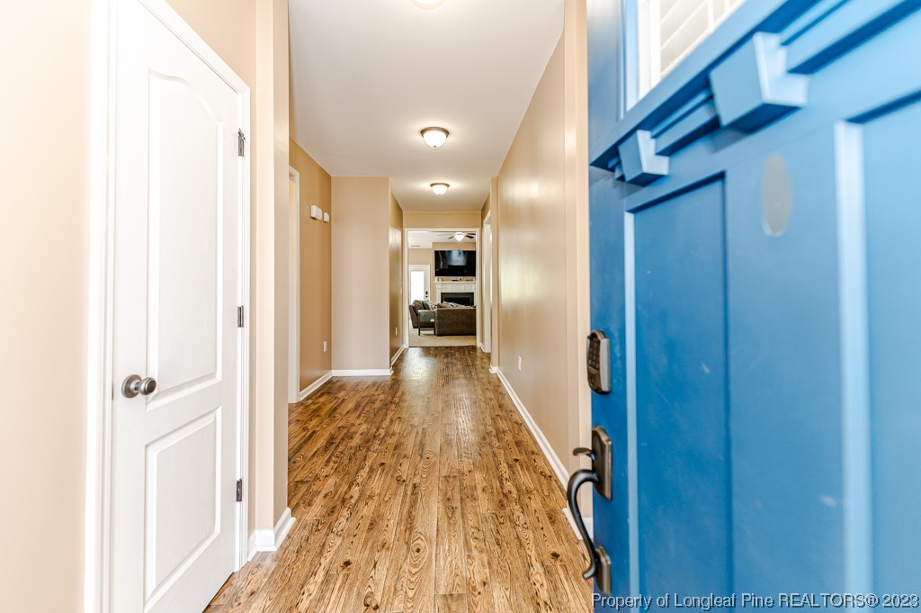 463 Juno Drive Broadway, NC 27505 - Photo 5 of 30 a view of a hallway with wooden floor and staircase