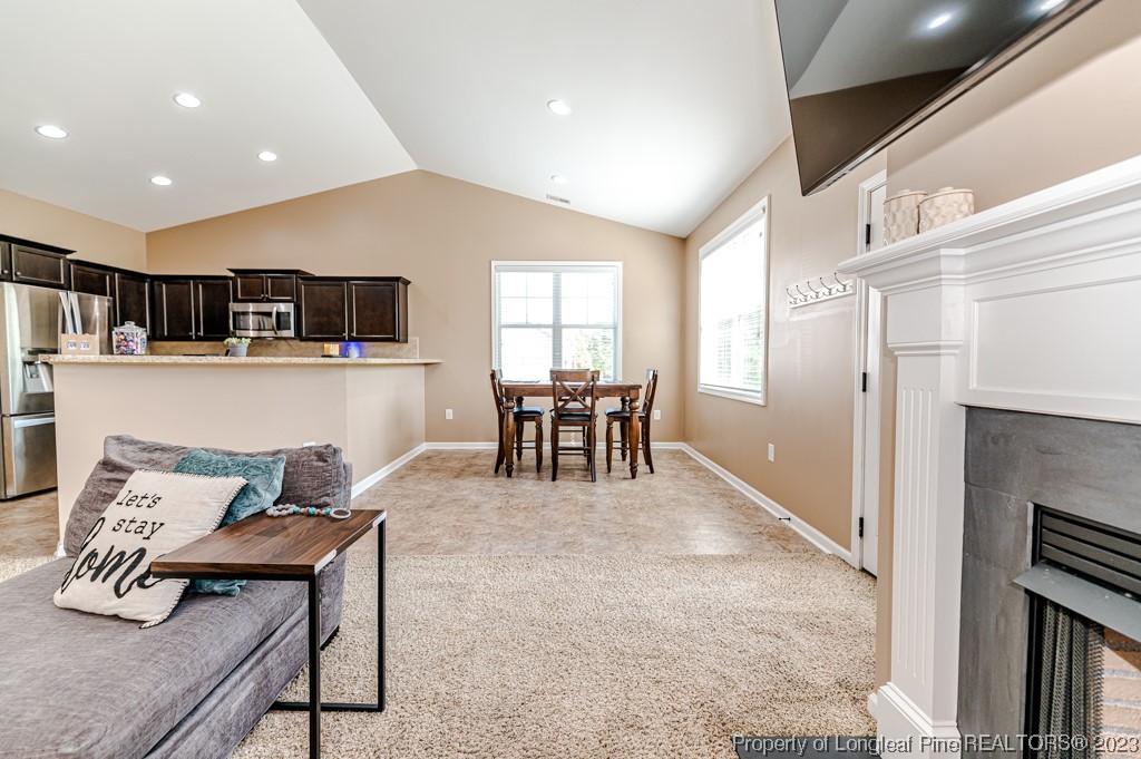 463 Juno Drive Broadway, NC 27505 - Photo 10 of 30 a living room with furniture and a dining table with kitchen view