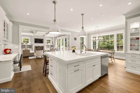 a dining room with furniture a chandelier and wooden floor