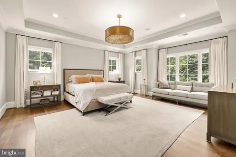 a bedroom with a large bed and a large window