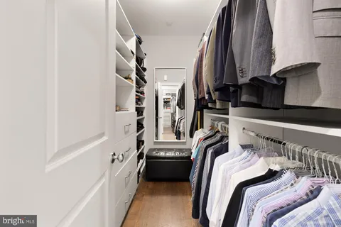 a large bed sitting in a bedroom next to a window and dresser