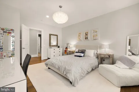 a living room with stainless steel appliances furniture and a kitchen view