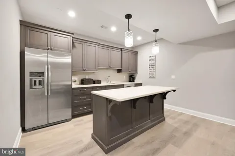 a front view of a house with a yard and trees