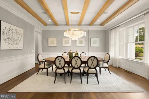a dining room with furniture and chandelier