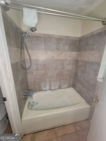 a bath tub sitting next to a shower