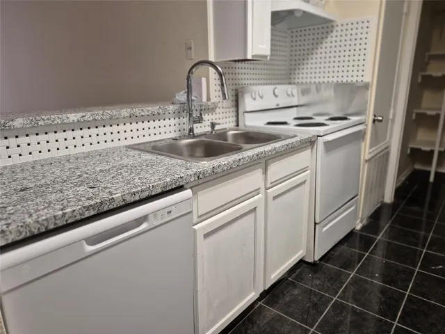 a close view of a sink and dishwasher in a kitchen