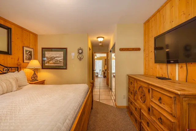 a bathroom with a sink a toilet a mirror a bathtub and shower