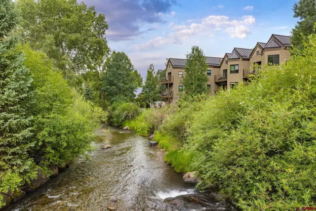 a wooden bench sitting in front of a house