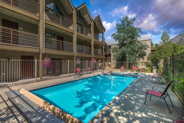 a view of a backyard with sitting area