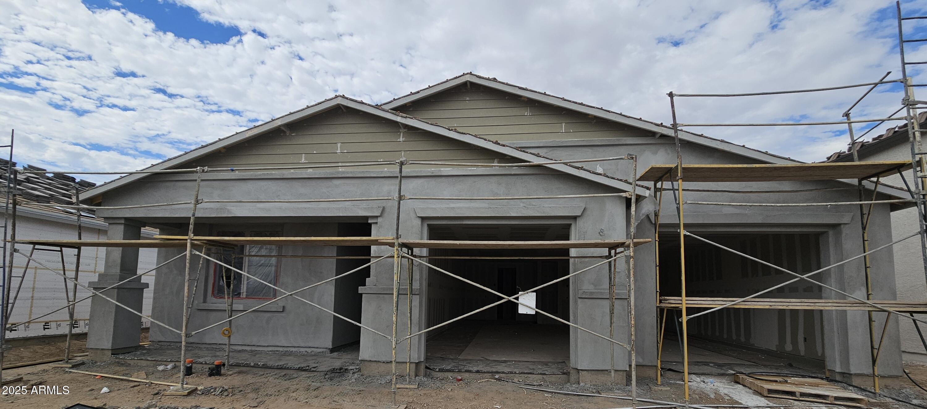2654 Rustler Road San Tan Valley, AZ 85140 - Photo 2 of 38 a wooden house with a large window and wooden fence