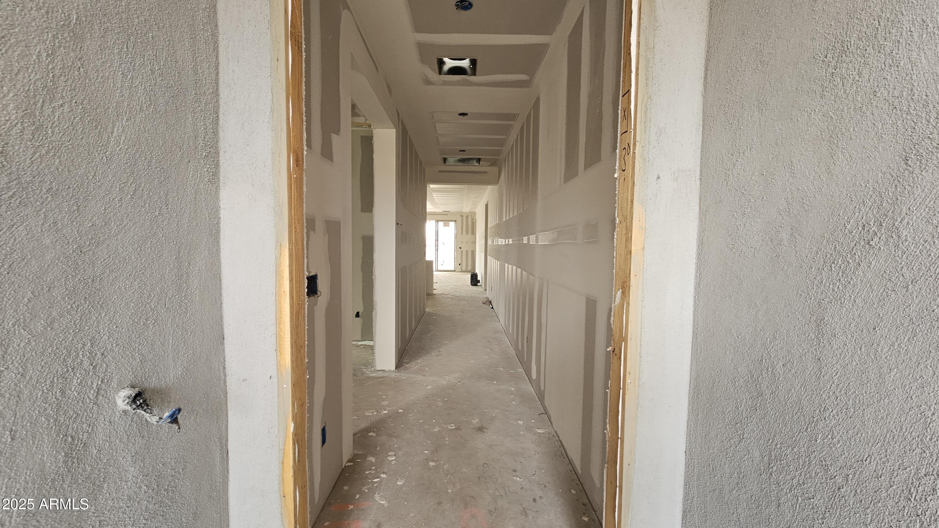 2654 Rustler Road San Tan Valley, AZ 85140 - Photo 3 of 38 a view of a hallway with a wooden cabinets