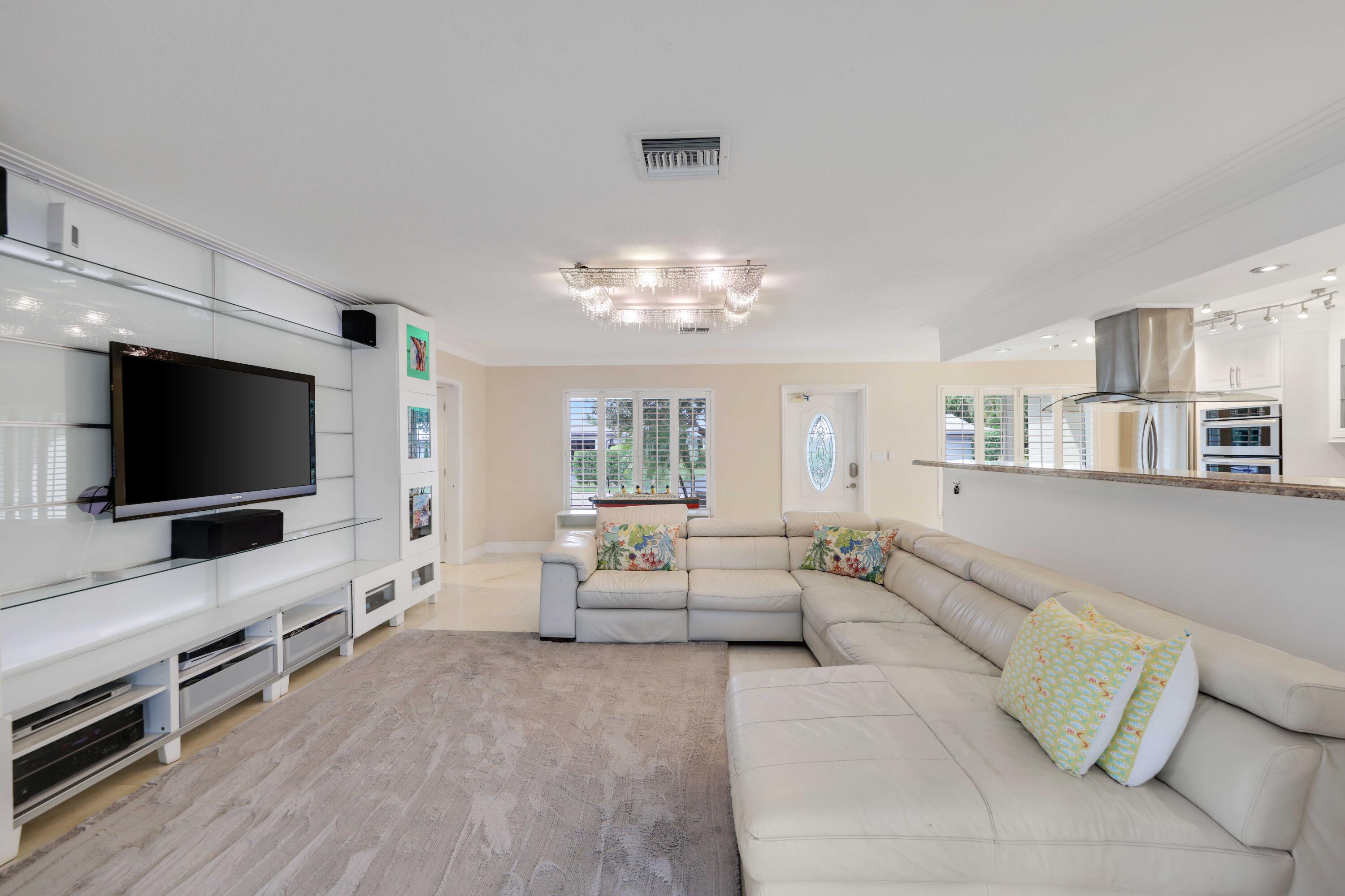 4220 Northeast 26th Terrace Lighthouse Point, FL 33064 - Photo 11 of 30 a living room with furniture and a flat screen tv