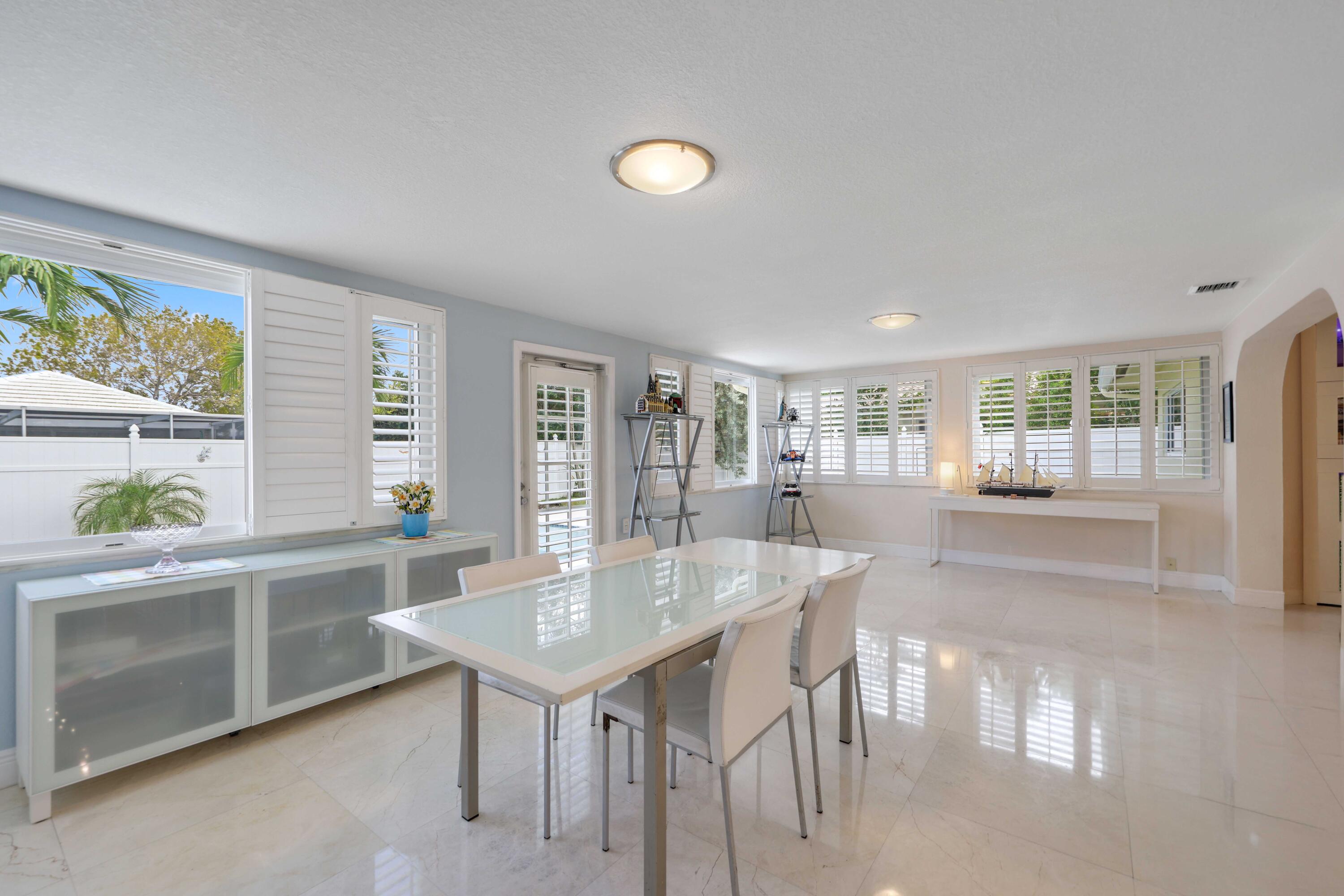 4220 Northeast 26th Terrace Lighthouse Point, FL 33064 - Photo 13 of 30 a view of a dining room with furniture and a potted plant