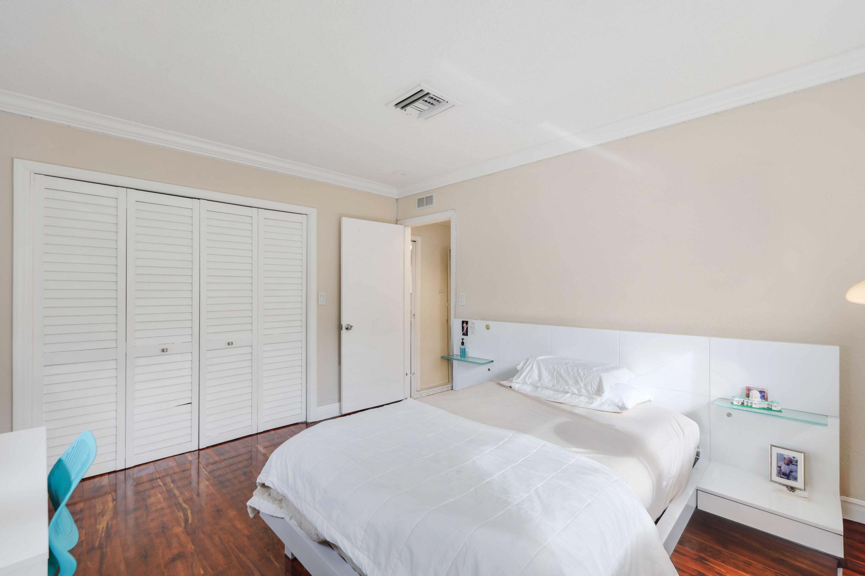 4220 Northeast 26th Terrace Lighthouse Point, FL 33064 - Photo 19 of 30 a bedroom with a bed and a dresser