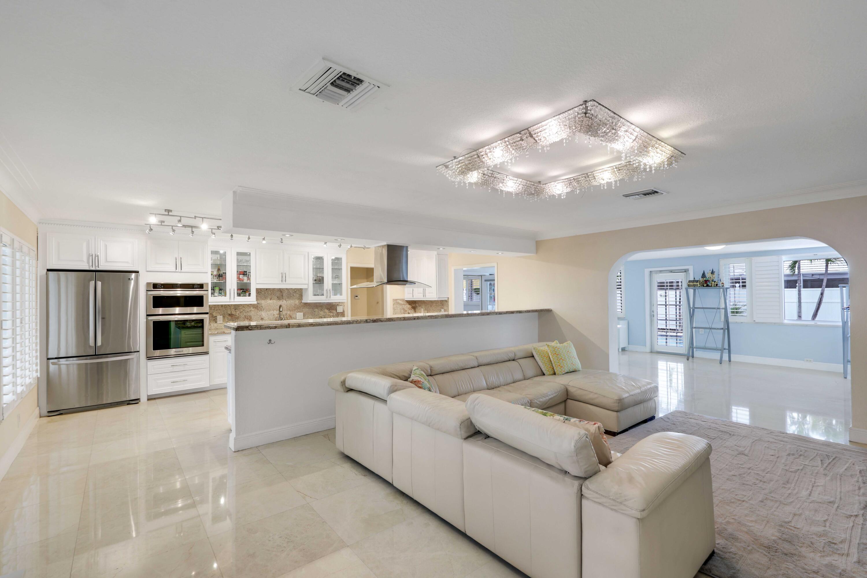 4220 Northeast 26th Terrace Lighthouse Point, FL 33064 - Photo 10 of 30 a living room with stainless steel appliances furniture and a kitchen view