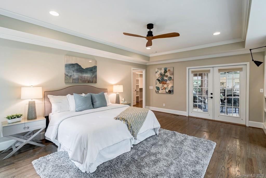 4200 Chelmsford Road Charlotte, NC 28211 - Photo 11 of 45 a spacious bedroom with a large bed and a chandelier