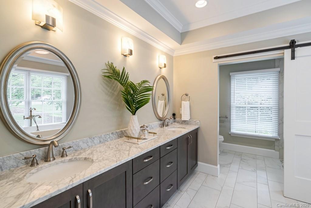 4200 Chelmsford Road Charlotte, NC 28211 - Photo 18 of 45 a bathroom with a granite countertop double vanity and a mirror