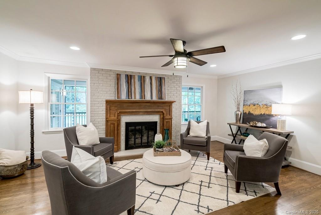 4200 Chelmsford Road Charlotte, NC 28211 - Photo 24 of 45 a living room with furniture a fireplace and a chandelier