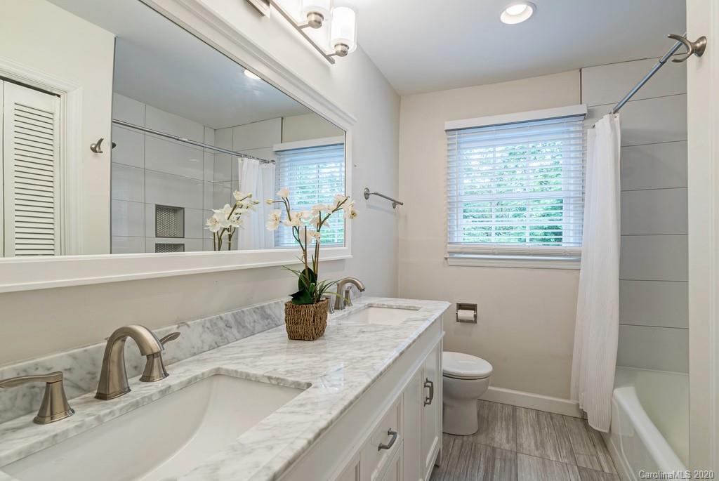 4200 Chelmsford Road Charlotte, NC 28211 - Photo 36 of 45 a bathroom with a granite countertop sink mirror vanity and toilet